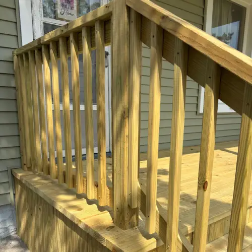 Close-up of new wooden deck railing and steps highlighting natural wood grain and craftsmanship by Union Properties in Mi