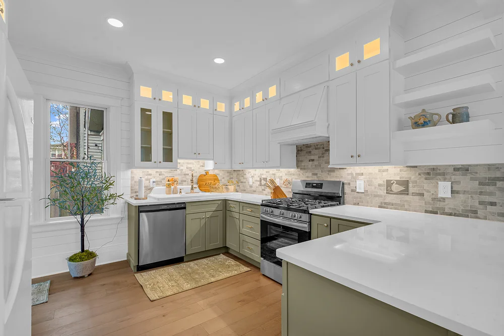 Modern kitchen remodel with green cabinets and white countertops by Union Properties, in Port Huron, MI