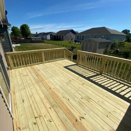 Brand new wooden deck after replacement project showing results of deck resurfacing vs replacement by Union Properties in Michigan