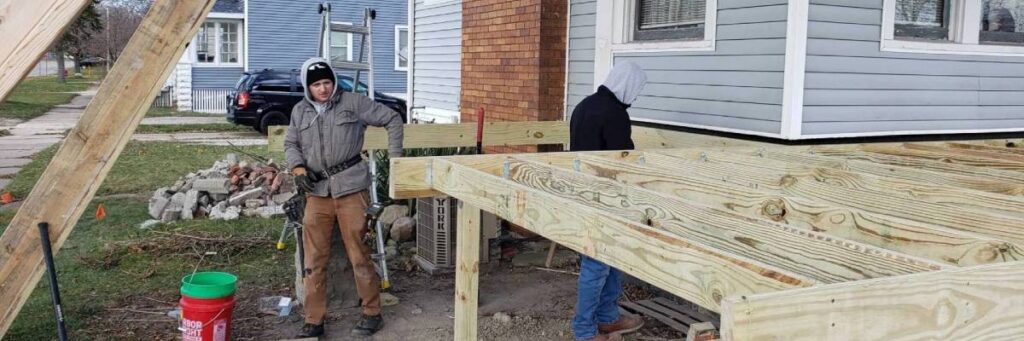 Construction team performing deck replacement showing the difference between deck resurfacing vs replacement by Union Properties in Michigan