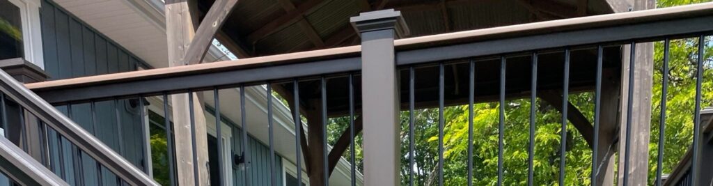 Modern multi level deck builder project with metal railings and overhead cover by Union Properties in Michigan