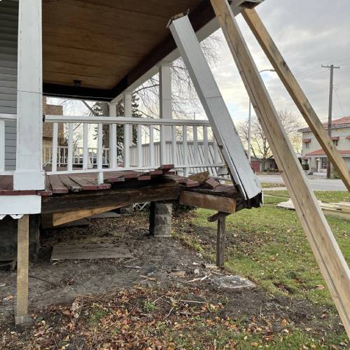 A deteriorated wooden deck before replacement highlighting deck resurfacing vs replacement by Union Properties in Michigan