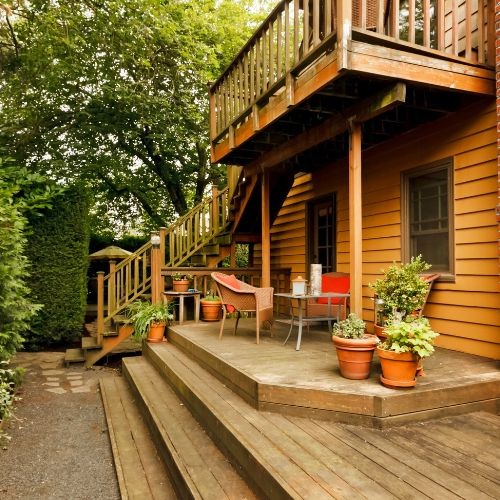 Multi level deck builder project with stairs, seating, and surrounding greenery by Union Properties in Michigan