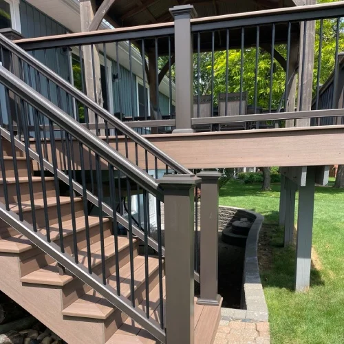 Composite deck with black railings and stair design by Union Properties in Michigan