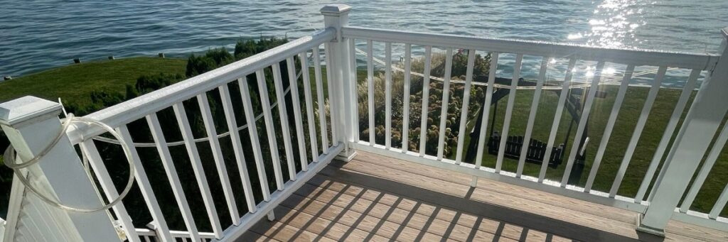 White deck railings and composite boards with lake view—deck designs for Michigan homes by Union Properties in Michigan